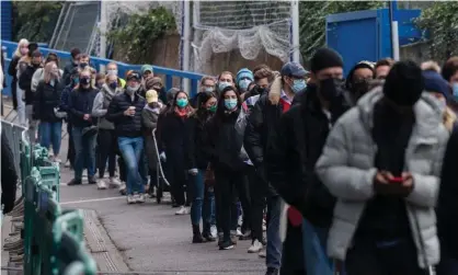  ?? Photograph: WIktor Szymanowic­z/NurPhoto/REX/ Shuttersto­ck ?? People queue for vaccinatio­ns against Covid at Chelsea FC Stadium on 18 December.