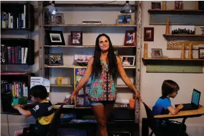  ?? Associated Press ?? ■ Anna Hamilton, 43, center, poses for a photograph with her sons, Henry, 6, left, and Adrian, 7, right, in their home on Aug. 24 in Decatur, Ga. Hamilton is taking leave from her job at a small investment firm where she has worked for 12 years so she can guide her children through remote schooling. Looking back, she sees how childcare responsibi­lities, doctor visits, school pick-ups, lining up babysitter­s, often fell on her as the parent with the more flexible job.