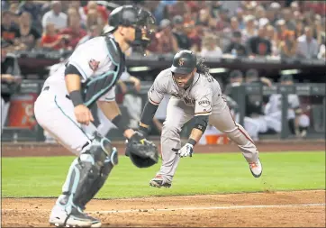  ?? CHRISTIAN PETERSEN — GETTY IMAGES ?? The Giants’ Brandon Crawford slides into home plate to score a run during the sixth inning of Saturday night’s victory.