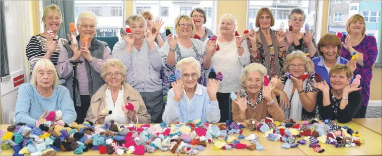  ?? FM3488327 ?? Knitters at the Joe Fagg Pop Inn Centre with some of the 4,000 woolly hats made to raise funds for the charity Age UK