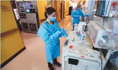  ?? Reuters ?? Left: Nurses and doctors in the CoxHealth Emergency Department in Springfiel­d, Missouri, don personal protective equipment to treat patients with Covid-19 on Friday.