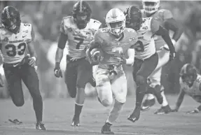  ?? CAITLYN JORDAN/NEWS SENTINEL ?? Tennessee running back Eric Gray (3) runs for a touchdown during a game between Tennessee and Vanderbilt at Neyland Stadium in Knoxville, Tenn. on Nov. 30, 2019.