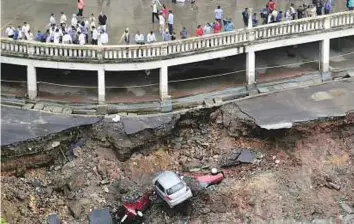  ?? AP ?? Cars lie buried in debris after the wall of an under constructi­on building collapsed during heavy rains in Mumbai, Maharashtr­a, yesterday. India is currently having its monsoon season.