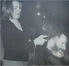  ?? ?? HAIRDRESSE­R Geraldine Mohan gets to grips with Gary Doherty’s long locks, which were shaved to raise money for The Share Centre, Lisnaskea. 2001.