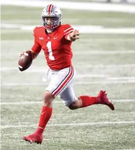  ?? Associated Press ?? ■ Ohio State quarterbac­k Justin Fields looks for an open receiver Nov. 7 during the second half of the team’s NCAA football game against Rutgers in Columbus, Ohio. Ohio State won, 49-27.