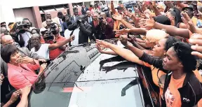  ??  ?? The popularity of Portia Simpson Miller never waned. Here, she greets party supporters outside Gordon House before making her final Budget Debate presentati­on to Parliament in March.