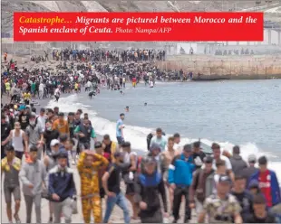  ?? Photo: Nampa/AFP ?? Catastroph­e… Migrants are pictured between Morocco and the Spanish enclave of Ceuta.