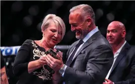  ??  ?? Margaret McGregor, mother of Conor, speaks with UFC CEO Lorenzo Fertitta