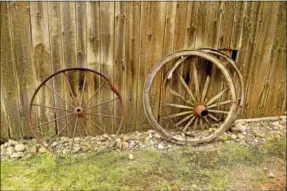  ?? PETER HVIZDAK — NEW HAVEN REGISTER ?? A view of wagon wheel artifacts by the Dudley Farm Museum Big Barn in Guilford .