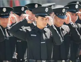  ?? Al Seib Los Angeles Times ?? TIFFANY SCHEIDLER, center, was one of five women in the Los Angeles Fire Department’s class of 2016. The newest class of recruits has nine women.