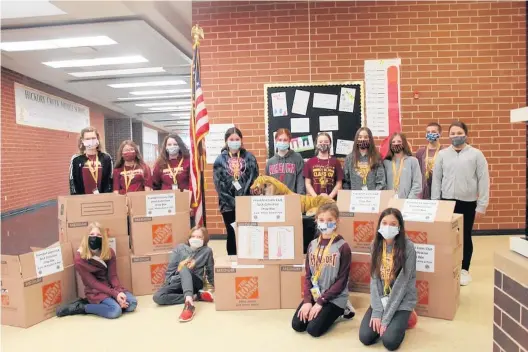  ?? SCHOOL DISTRICT 157-C ?? Student council members at HickoryCre­ek Middle School in Frankfort show off the more than 3,000 pairs of socks they collected in a recent sock drive for the homeless.