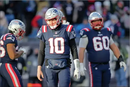  ?? STUART CAHILL — BOSTON HERALD ?? New England Patriots quarterbac­k Mac Jones (10) walks off the field after being sacked as the Patriots take on the Bengals at the Gillette on December 24, 2022 in, Foxboro.