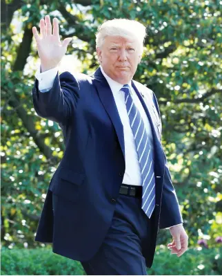  ??  ?? President Donald Trump waves as he walks on the South Lawn of the White House in Washington, DC, before his departure to Groton, Connecticu­t, on Wednesday. (Reuters)