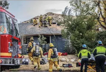  ?? Bobby Block/The Signal ?? Firefighte­rs respond to a house fire in Canyon Country that resulted in the death of two people inside, a man and a woman. The man has been identified by medical examiners as Bernard Halio, 82.