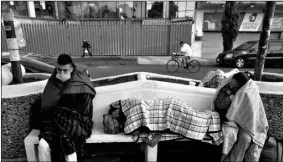  ?? AP Photo/Rebecca Blackwell ?? People sit bundled up against the cold after spending the night waiting for news of relatives being treated for suspected COVID-19, outside the Mexico General Hospital, in Mexico City, Tuesday. Mexican officials said Monday that more than 100 medical personnel have died from the novel coronaviru­s, while thousands have been infected.