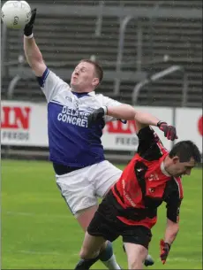  ??  ?? Ballyhogue full-back Seán Rochford goes highest to win this duel with Graham Sinnott of Bannow-Ballymitty.