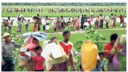  ?? – Reuters ?? Horrific nightmare: Rohingya refugees crossing the border into Bangladesh from Myanmar in 2017 to flee the violence. Many are now living in fear as the Bangladesh government plans to repatriate about 2,000 of the refugees this month.