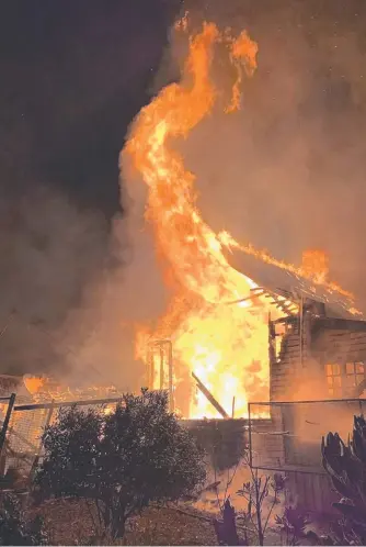  ?? ?? Fire rips through a historic 150-year-old weatherboa­rd home at Red Hills, leaving charred remains and broken dreams for the family. Main picture: Deloraine Fire Brigade