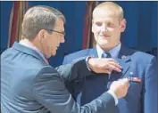  ?? MICHAEL REYNOLDS
European Pressphoto Agency By Paige St. John and Christine Mai-Duc ?? SPENCER STONE, honored after the French attack, was hurt Thursday in Sacramento.