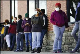  ?? MATT ROURKE — THE ASSOCIATED PRESS FILE ?? People wait in line to receive COVID-19 vaccines at a site in Philadelph­ia. Nearly half of new coronaviru­s infections nationwide are in just five states, including Pennsylvan­ia.