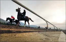  ?? Al Seib Los Angeles Times ?? HORSES AND JOCKEYS train at Santa Anita this month. The track has been closed since March 5 while the deaths of horses are being investigat­ed.