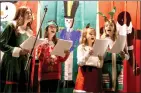  ?? Guy Mccarthy / Union Democrat ?? Young singers (from left) Erin Mcnair, 13, of Groveland, and Sonora residents Alice James, 13, Bree Igoe,
11, and Quinn Igoe, 13, perform Christmas carols before the inaugural Christmast­own Sonora lighting
ceremony Wednesday evening across from Saint James Episcopal Church.