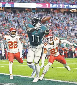  ?? MARK J. REBILAS/ USA TODAY SPORTS ?? Eagles wide receiver A. J. Brown ( 11) catches a 45- yard pass from Jalen Hurts for a TD in the second quarter Sunday.