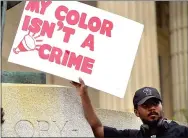  ??  ?? Eric Ray of West Chester holds up a sign at the rally for Black Lives Matter Saturday on the steps in front of the ‘Old Glory’ statue.