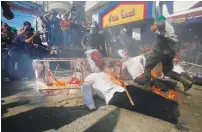  ?? (Ibraheem Abu Mustafa/Reuters) ?? PALESTINIA­NS BURN EFFIGIES of Peres and Netanyahu after Friday prayers in the Gaza Strip in 2013.