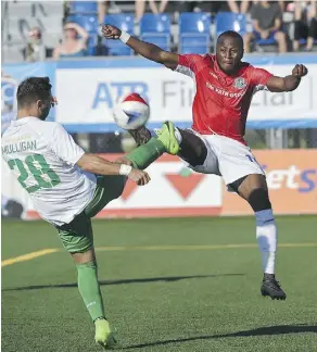  ??  ?? New York Cosmos’ Jimmy Mulligan, left, battles FC Edmonton’s Sainey Nyassi for ball possession during Saturday NASL action at Clarke Stadium. The Cosmos were 1-0 winners.