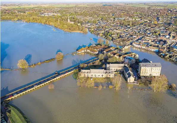  ??  ?? The town of St Ives in Cambridges­hire is surrounded by rising flood water yesterday morning after the Great Ouse overwhelme­d river defences following more recent heavy rainfall.