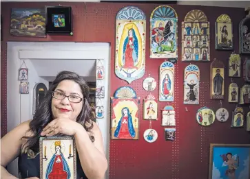  ?? ROBERTO E. ROSALES/JOURNAL ?? Shawna Chavez holds one of the retablos she paints and sells in the small gallery she and her husband own next to their home in Chimayó. Holy Week is the couple’s busiest time of year.