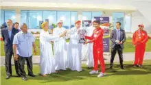  ??  ?? Oman Under-19 captain Prathamesh Kumble presenting the winner’s trophy to OC Chairman Kanak Khimji