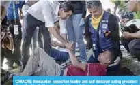  ??  ?? CARACAS: Venezuelan opposition leader and self declared acting president Juan Guaido (left) greets volunteers of the movement ‘Aid and Freedom Venezuela Coalition’ who fainted during a rally in Caracas. —AFP