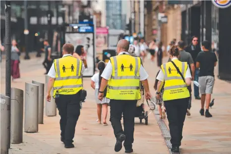  ?? Picture: AFP ?? Metrolink workers in Manchester in northwest England wear high-vis jackets with a message urging social distancing amid fears that the country could face a second wave of the coronaviru­s.