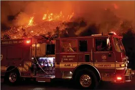  ?? NOAH BERGER — THE ASSOCIATED PRESS FILE ?? A firefighte­r prepares to battle the Cave Fire as it flares up along Highway 154in the Los Padres National Forest, above Santa Barbara.