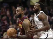  ?? TONY DEJAK — ASSOCIATED PRESS ?? LeBron James drives against the Nets’ DeMarre Carroll during the second half Feb. 27. James had 31 points, 12 rebounds and 11 assists in a 129-123 win.