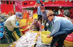  ?? NICOLAS ASFOURI/AFP ?? Migrant workers sort fish on a Thai fishing boat. An appeal of the case filed by Cambodian workers alleging they suffered abuse from their Thai employers was denied this week.