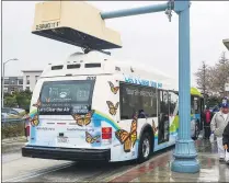  ?? PHOTO BY KEITH DURFLINGER ?? Foothill Transit operates an electric bus built by Proterrra in 2017. One of 15 electric buses pulls on Line 291 and self-charges through an overhead charger at a bus station in Pomona. The agency’s electric bus fleet has been beset by problems recently.