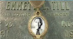  ??  ?? Emmett Till’s photo adorns his grave in Alsip. | SUN- TIMES FILES