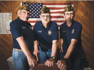  ?? STAFF PHOTO BY TIM BARBER ?? From left, Senior Vice Commander Larry Helms, Commander John Croteau and Junior Vice Commander Bill O’Connor stand in Croteau’s office Thursday at the VFW Post 1289 on Lee Highway.