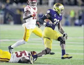  ?? Carlos Osorio Associated Press ?? NOTRE DAME RAN and ran against USC last week, including Josh Adams on this play, handing the Trojans their second-worst defeat in the series.