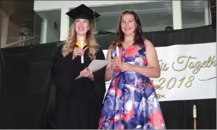  ?? Photo Submitted to The McLeod River Post ?? Holy Redeemer Graduate Kaitlyn Krebs participat­ed in the Light of Learning Ceremony with her younger sister Ella at the HRH Graduation on May 26.