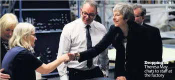  ??  ?? Dropping in Theresa May chats to staff at the factory