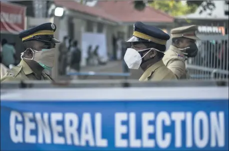  ?? AP PHOTO/R S IYER ?? Indian policemen guard at a vote counting center for the state legislatur­e elections amid a weekend lockdown to curb the spread of coronaviru­s Kochi, Kerala state, India, May 2.