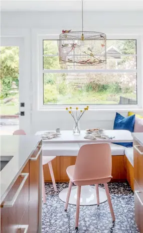  ??  ?? ABOVE “A table with four chairs eats up so much space because you have to have clearance to come in and out of the table,” Ami explains. “By adding a banquette here, we could push the table back further so we’d have more workspace in the kitchen.”
CHANDELIER, Etsy; PILLOWS, Anara Design Company.