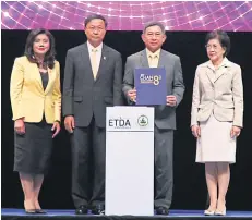  ??  ?? Deputy Prime Minister Prajin Juntong (second right) and DE Minister Pichet Durongkave­roj (second left) celebrate the eighth anniversar­y of the ETDA with chairwoman Jirawan Boonperm (right) and executive director Surangkana Wayuparb.