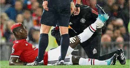  ?? — Reuters ?? That painful day: Manchester United’s Paul Pogba receiving medical attention after sustaining an injury in the Champions League match against Basel in September.