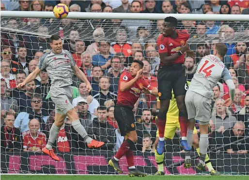  ?? AFP ?? Liverpool’s James Milner (left), Alexis Sanchez (second from left), Paul Pogba of Manchester United and Liverpool’s Jordan Henderson (right) go up for a header. —