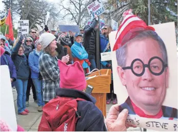  ?? MATT VOLZ, AP ?? A crowd gathers at the Montana State Capitol in Helena after GOP Sen. Steve Daines canceled a speech before Montana lawmakers Tuesday. The protesters had demanded a town hall meeting.